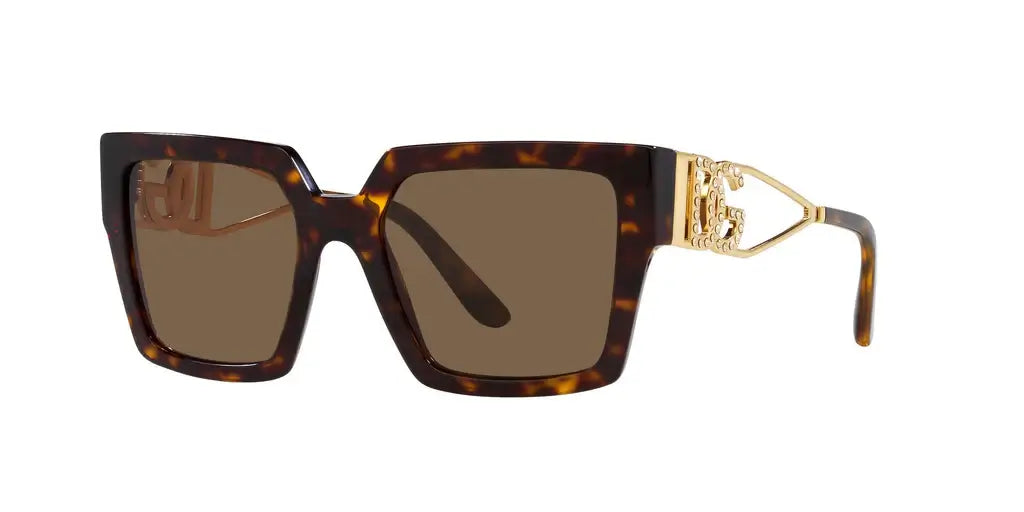 Dolce & Gabbana 0DG4446B oversized sunglasses with gold accents and a tortoiseshell frame. Stylish and chic eyewear.