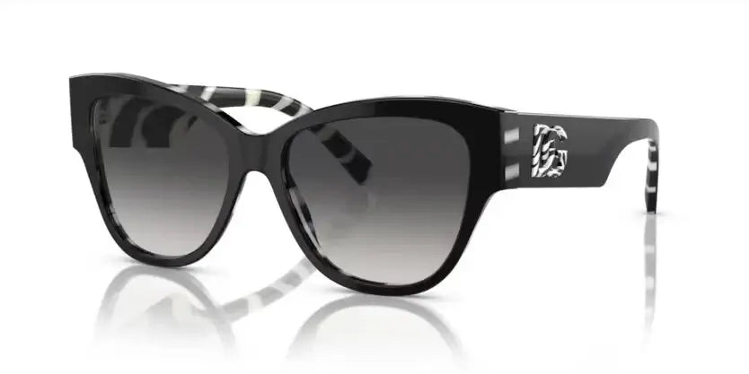 Dolce & Gabbana 0DG4449 sunglasses featuring a stylish black and white design with gradient lenses.